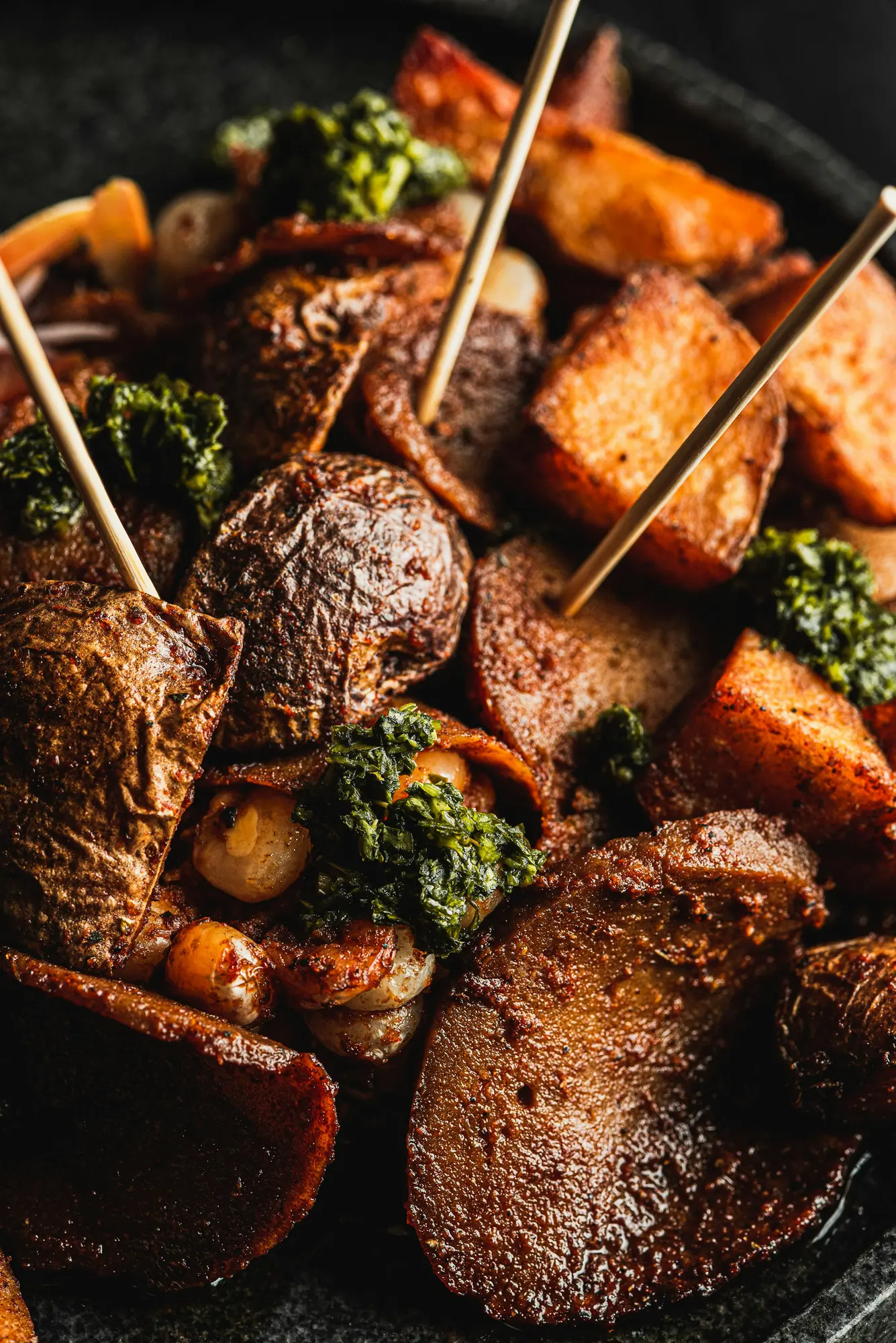 Browned roasted root vegetables with green herbs